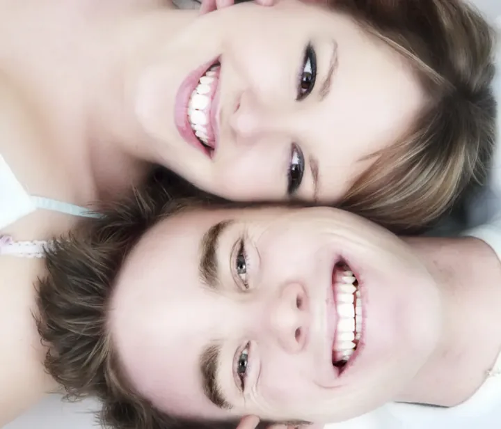 Smiling couple showing healthy teeth